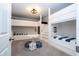 Spacious bunkroom featuring custom built-in bunks, carpet and nautical décor for the perfect kid getaway at 1505 Nassau Point Trl, Kissimmee, FL 34747