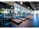 Well-equipped gym featuring state-of-the-art treadmills, mirrors, and ample natural light from large windows at 1505 Nassau Point Trl, Kissimmee, FL 34747