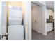 Convenient laundry area featuring a stackable washer and dryer unit, optimizing space and adding functionality at 1505 Nassau Point Trl, Kissimmee, FL 34747