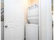 Efficient laundry space with stacked washer/dryer unit maximizing space and functionality in the home at 1505 Nassau Point Trl, Kissimmee, FL 34747