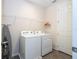 Well-equipped laundry room featuring modern washer and dryer units for convenient home care at 1505 Nassau Point Trl, Kissimmee, FL 34747