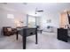 Bright living room featuring comfortable seating, ceiling fan, and foosball table for added entertainment at 1505 Nassau Point Trl, Kissimmee, FL 34747