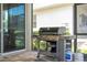 Outdoor grill area on the patio with a gas grill and propane tanks at 1505 Nassau Point Trl, Kissimmee, FL 34747