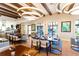 Cozy restaurant features tables and chairs, beamed ceilings, and ring-shaped chandeliers for an inviting atmosphere at 1505 Nassau Point Trl, Kissimmee, FL 34747