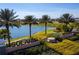 Community signage for Solara Resort set against the backdrop of a lake, landscaping, and palm trees at 1505 Nassau Point Trl, Kissimmee, FL 34747
