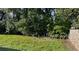 Backyard featuring lush green grass surrounded by trees for privacy at 1511 Hobson St, Longwood, FL 32750