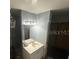 Bathroom with a white vanity, mirror, and modern lighting fixture, next to a shower with dark curtains at 1511 Hobson St, Longwood, FL 32750