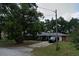 View of the charming one-story home with a front lawn and ample parking on the driveway at 1511 Hobson St, Longwood, FL 32750