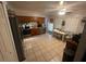 Bright eat-in kitchen features tile floor and wooden cabinets with a stainless steel fridge and other appliances at 1511 Hobson St, Longwood, FL 32750