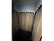 Incomplete shower displaying metal frame and dark shower pan, with drywall removed and blue paint above at 1511 Hobson St, Longwood, FL 32750
