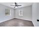 This bedroom features two windows, wood floors, and a ceiling fan at 1533 Fort Smith Blvd, Deltona, FL 32725