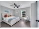 Comfortable bedroom featuring a bed, chair, ceiling fan, and natural light at 1533 Fort Smith Blvd, Deltona, FL 32725