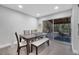 Dining area with modern table and chairs, flowing seamlessly into the screened patio at 1533 Fort Smith Blvd, Deltona, FL 32725