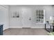 Bright entryway with white door, gray walls, light-colored wood floors, and a window with light-filtering blinds at 1533 Fort Smith Blvd, Deltona, FL 32725