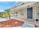 Inviting front entry with a blue door, well-maintained yard, and manicured landscaping at 1533 Fort Smith Blvd, Deltona, FL 32725