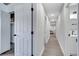 Hallway with wood floors leads to bedrooms and bathrooms at 1533 Fort Smith Blvd, Deltona, FL 32725