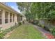 Backyard of home with a lush lawn, mature trees, and a charming garden path at 1542 Islay Ct, Apopka, FL 32712