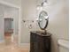 Elegant bathroom featuring a vanity, decorative mirror, and travertine floors at 1542 Islay Ct, Apopka, FL 32712