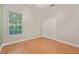 Bedroom featuring wood floors, a double door closet, and a window with blinds at 1542 Islay Ct, Apopka, FL 32712