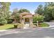 Exterior view of beautiful home featuring red tile roof, fountain, and lush landscaping at 1542 Islay Ct, Apopka, FL 32712