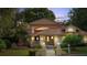 Charming two-story home at dusk, featuring a red tile roof, meticulously landscaped yard, and inviting fountain feature at 1542 Islay Ct, Apopka, FL 32712