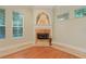 Elegant fireplace with decorative mantle and hearth, flanked by windows for natural light at 1542 Islay Ct, Apopka, FL 32712