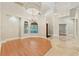 Elegant entryway showcasing soaring ceilings, a stylish chandelier, and exquisite tile flooring design at 1542 Islay Ct, Apopka, FL 32712