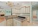 Kitchen with island and granite countertops opens to living room with fireplace at 1542 Islay Ct, Apopka, FL 32712