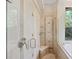 Walk-in shower with tile surround, bench, and glass door with views of the backyard at 1542 Islay Ct, Apopka, FL 32712