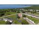 Aerial view of a residential area with lush green surroundings and a lake in the background at 1543 Club Cir, Lakeshore, FL 33854