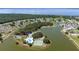 Aerial view highlighting the community's extensive amenities, including a pool, tennis courts, and lakeside access at 1543 Club Cir, Lakeshore, FL 33854