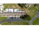 Overhead view of a condominium complex with a parking lot, green space, and clearly defined property lines at 1543 Club Cir, Lakeshore, FL 33854