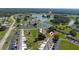 Aerial view of community featuring lake, lush landscaping, and various community buildings at 1543 Club Cir, Lakeshore, FL 33854