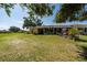 Spacious backyard featuring a charming patio with a golf cart and well-maintained lawn at 1543 Club Cir, Lakeshore, FL 33854