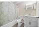 Bathroom with white vanity, toilet, and a bathtub with a decorative shower curtain at 1543 Club Cir, Lakeshore, FL 33854
