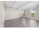 Bedroom featuring light gray flooring, two windows letting in natural light, and an exposed beam ceiling at 1543 Club Cir, Lakeshore, FL 33854