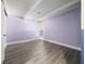 Bedroom featuring light gray flooring, a window letting in natural light, and a lilac-colored wall at 1543 Club Cir, Lakeshore, FL 33854