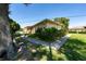 Charming exterior view showcasing well-maintained landscaping, including vibrant green bushes and grassy areas at 1543 Club Cir, Lakeshore, FL 33854