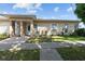 Inviting exterior of a home with a well-maintained lawn and a walkway leading to the front door at 1543 Club Cir, Lakeshore, FL 33854