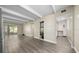 Open-concept living space with wood-look flooring, exposed beams, leading to the screened porch and kitchen at 1543 Club Cir, Lakeshore, FL 33854