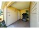 Enclosed patio area with a treadmill, beige siding, and an exterior door at 1543 Club Cir, Lakeshore, FL 33854