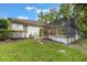 Landscaped backyard with a screened-in pool and patio at 1874 Royal Majesty Ct, Oviedo, FL 32765