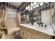 Elegant bathroom with patterned wallpaper, dual vanity sinks, a tub, and shutters at 1874 Royal Majesty Ct, Oviedo, FL 32765