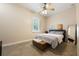 Cozy bedroom with a ceiling fan, carpet, and a comfortable bed by the window at 1874 Royal Majesty Ct, Oviedo, FL 32765