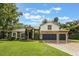 Lovely home featuring a three-car garage, stone accents, and a lush green lawn at 1874 Royal Majesty Ct, Oviedo, FL 32765