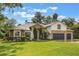 Charming home with a well-maintained lawn, stone accents, and mature trees at 1874 Royal Majesty Ct, Oviedo, FL 32765