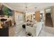 Spacious living room with a stone fireplace, stairs, and a view of the kitchen at 1874 Royal Majesty Ct, Oviedo, FL 32765
