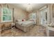 Luxurious main bedroom with a chandelier, French doors, and natural light at 1874 Royal Majesty Ct, Oviedo, FL 32765