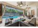 Inviting screened-in pool area featuring a spa, outdoor seating, and ceiling fans at 1874 Royal Majesty Ct, Oviedo, FL 32765
