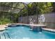 Tranquil pool featuring fountain features and a screened-in enclosure at 1874 Royal Majesty Ct, Oviedo, FL 32765